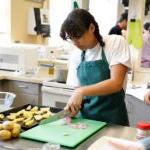 A student in a culinary arts class prepares ingredients